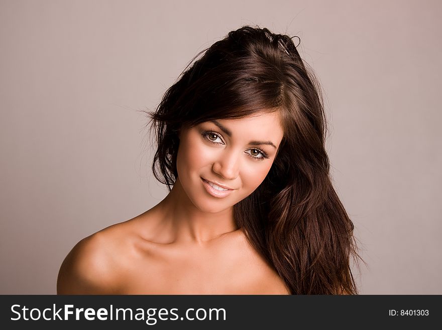 Beautiful young brunette woman with bare shoulders. Beautiful young brunette woman with bare shoulders