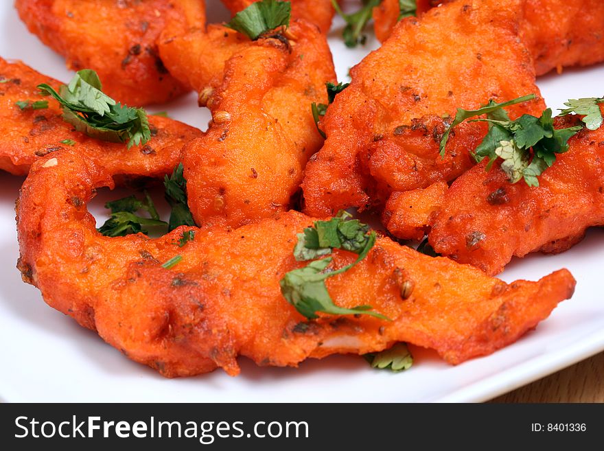 Tasty and spicy fried fish in white plate ready to eat