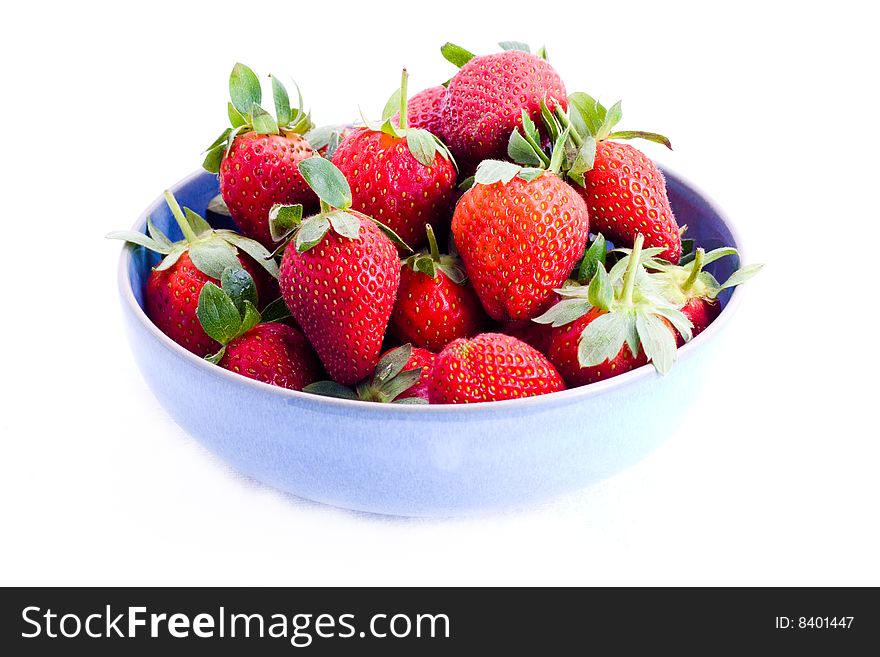 A bowl of fresh strawberries with stems. A bowl of fresh strawberries with stems