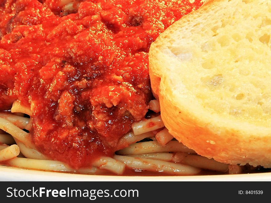 A closeup of spaghetti with a slice of bread. A closeup of spaghetti with a slice of bread.
