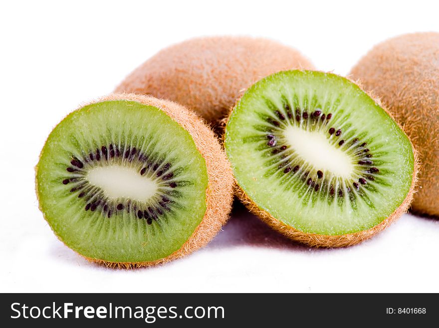 A close up of a halved kiwi fruit on white. A close up of a halved kiwi fruit on white