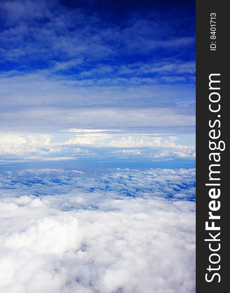 Aerial view of cloudy blue sky from aircraft window. Aerial view of cloudy blue sky from aircraft window.