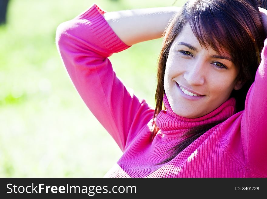 Young smiling woman over green background.