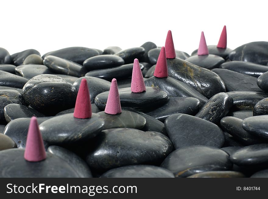 A row of incense cones on pebbles. A row of incense cones on pebbles