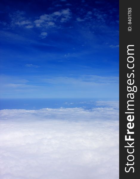 Aerial view of cloudy blue sky from aircraft window. Aerial view of cloudy blue sky from aircraft window.