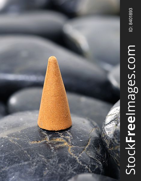 A row of incense cones on pebbles. A row of incense cones on pebbles