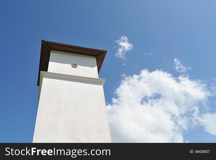 Tower of a catholic church against a blue sky. Tower of a catholic church against a blue sky