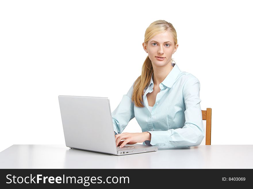 A business woman on her laptop at a desk isolated on white