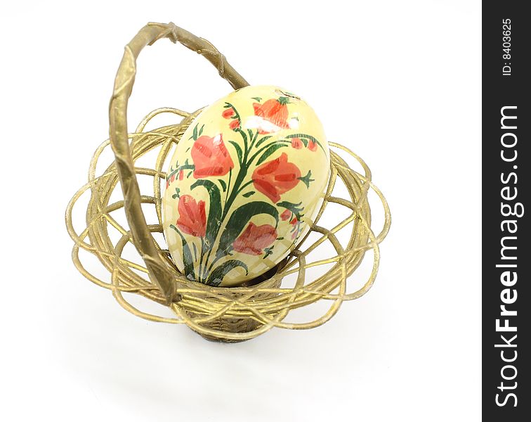 Antique Easter egg and basket isolated on a white background.