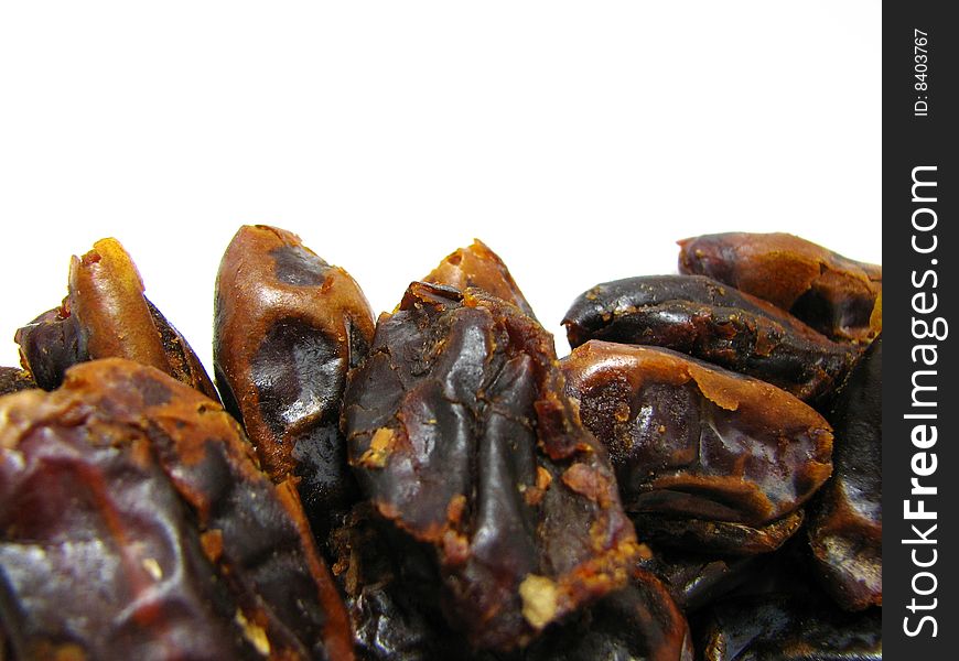 Macro photograph of dried and pitted dates from imported from Iran, isolated on white background. Macro photograph of dried and pitted dates from imported from Iran, isolated on white background