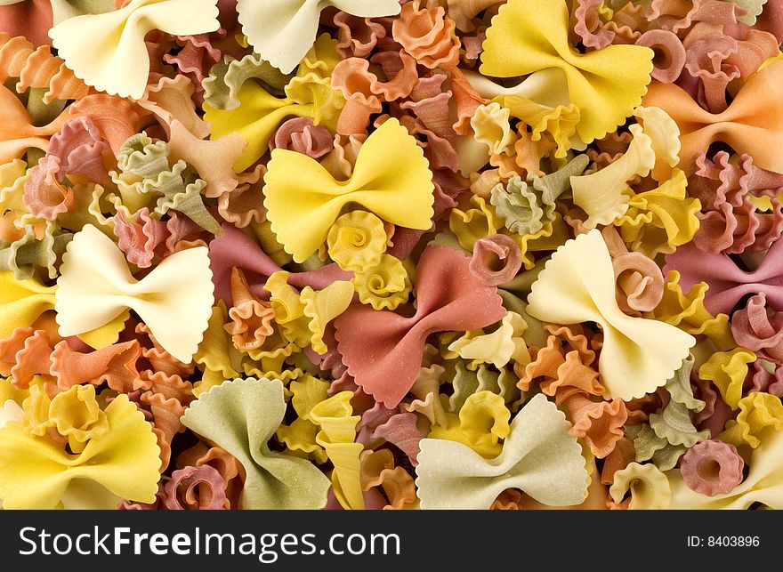 Colorful bow and spiral shaped vegetable pasta macro