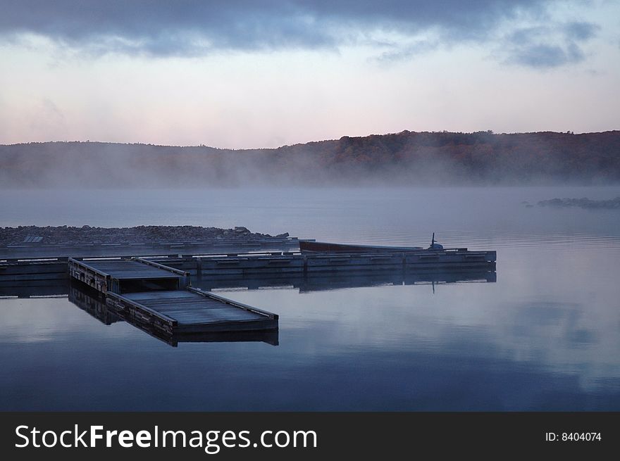 Dock in the mist at sunrise on Flack lake, Ontario. Dock in the mist at sunrise on Flack lake, Ontario