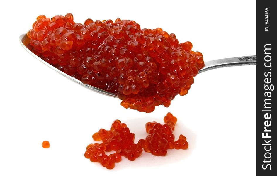 Red caviar on a spoon over white background. Red caviar on a spoon over white background