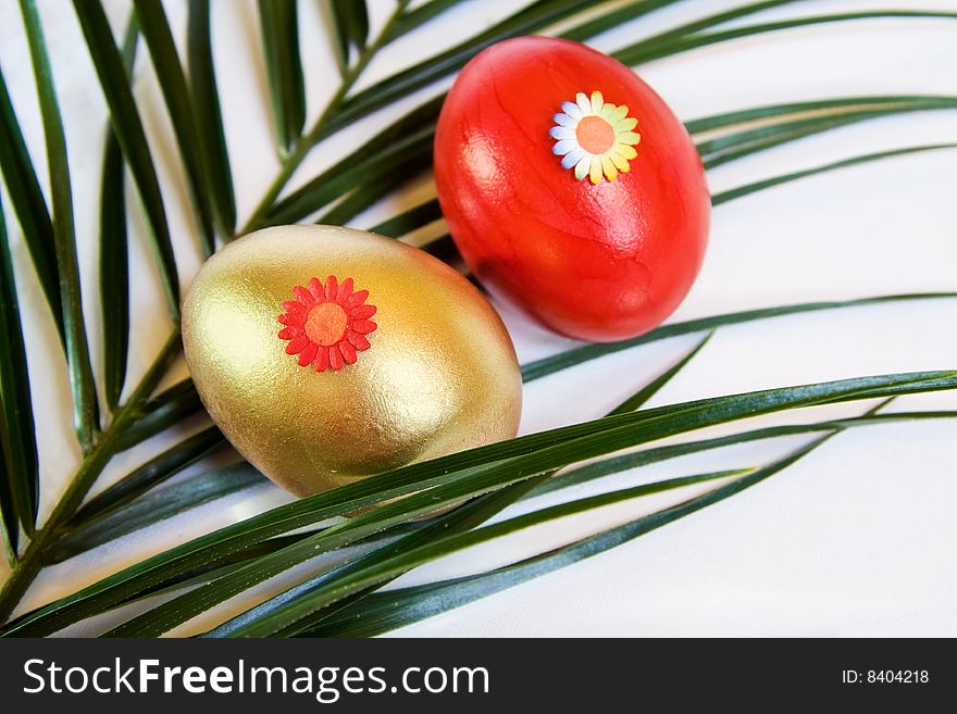 Easter spring celebration with red and golden eggs over decorative leaf. Easter spring celebration with red and golden eggs over decorative leaf.