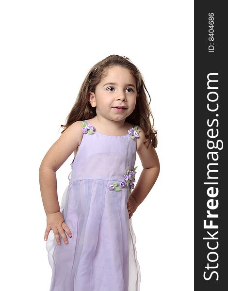 Beautiful young girl dressed in a lilac mauve dress with decorative flower accents. Beautiful young girl dressed in a lilac mauve dress with decorative flower accents.
