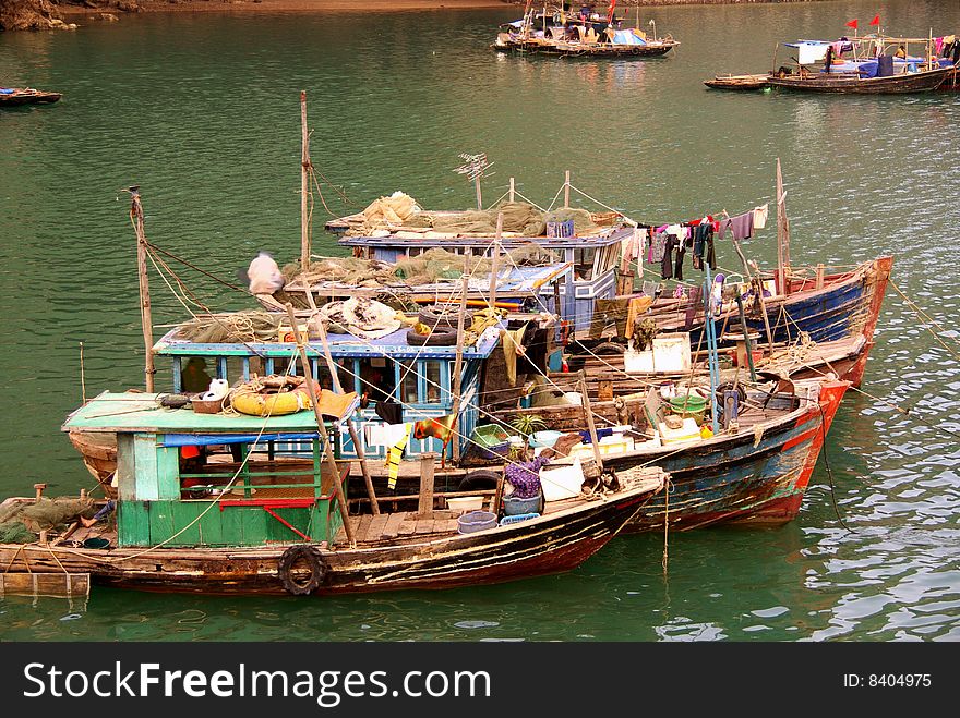 Fishing boats at the floating village in Halong bay in Vietnam