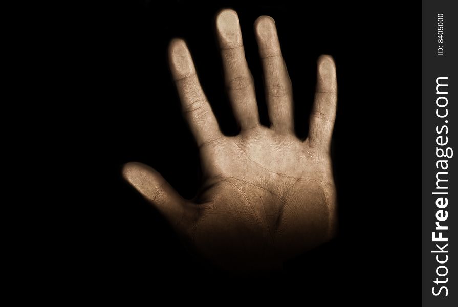 Hand coming through the black background and reaching toward the light