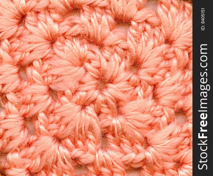 The handmade wool knitted pattern, background, closeup. The handmade wool knitted pattern, background, closeup.