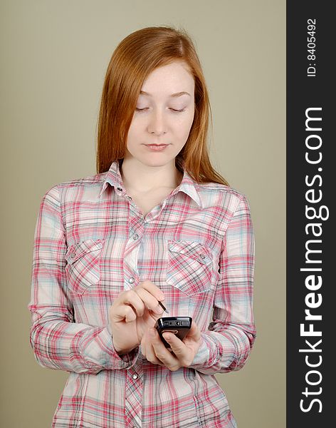 Redhead young woman writes in the PDA