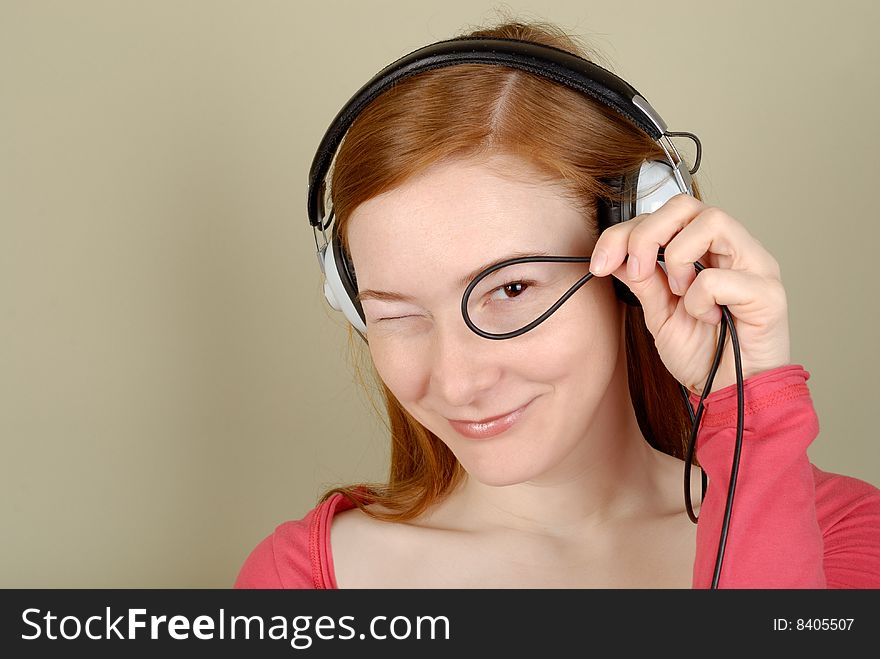 Redhead young woman in headphones with copy space