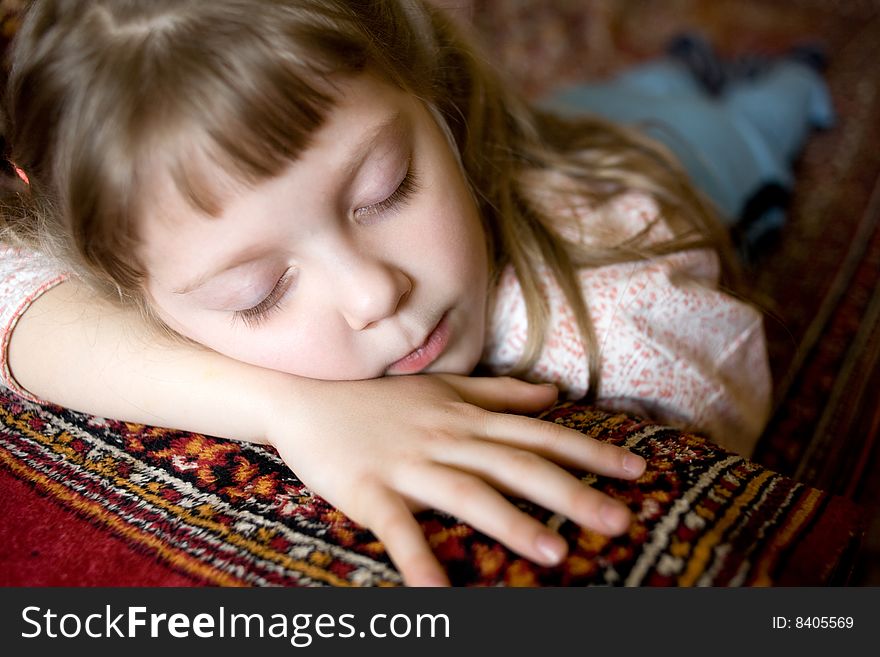 Stock photo: an image of a beautiful little girl sleeping on a sofa. Stock photo: an image of a beautiful little girl sleeping on a sofa