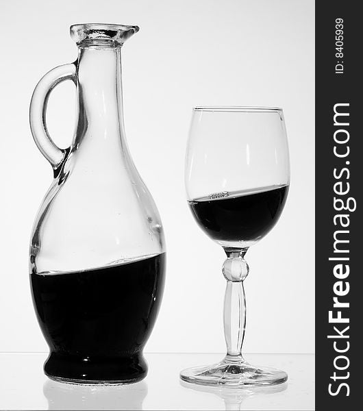 Jug and glass with red wine.