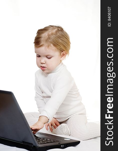 Stock photo: an image of a baby with black laptop