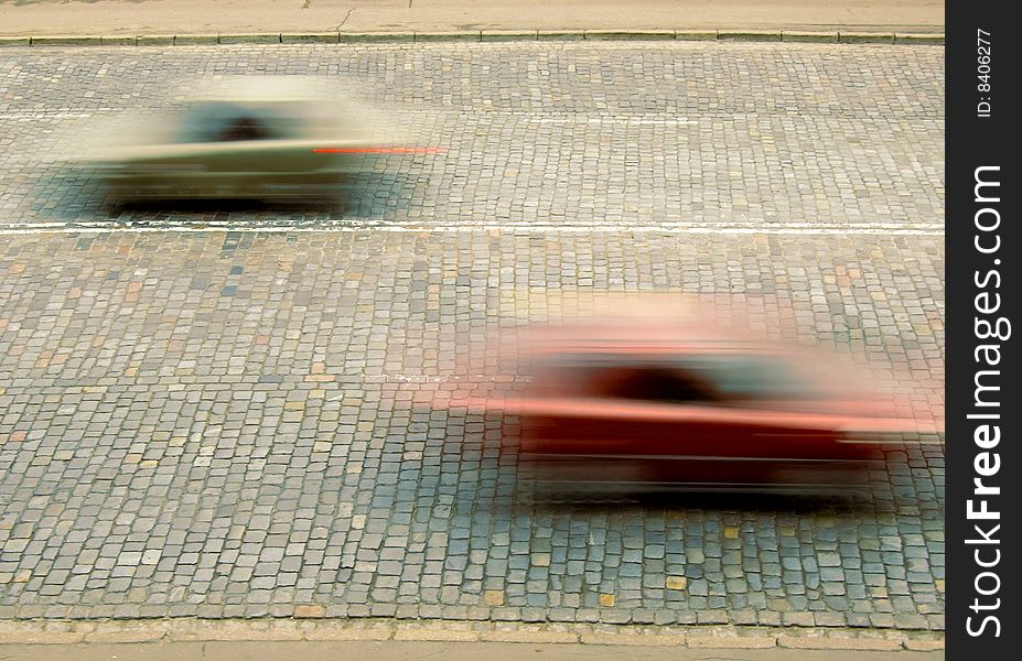 Traffic with motion blur on stone sett paving