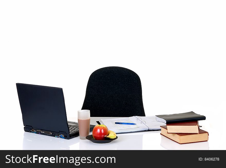 Homework with laptop and books on desk, with background, reflective surface. Homework with laptop and books on desk, with background, reflective surface