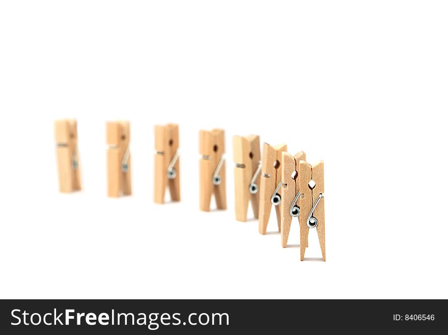 Clothes pegs in formation isolated in white background