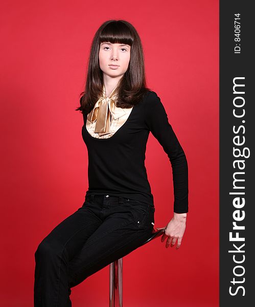 Girl sitting on a chair in studio