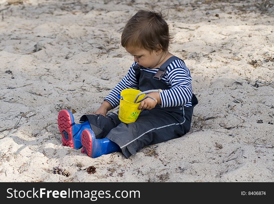 Child  in sailor's striped vest exploring the outside  world. Child  in sailor's striped vest exploring the outside  world