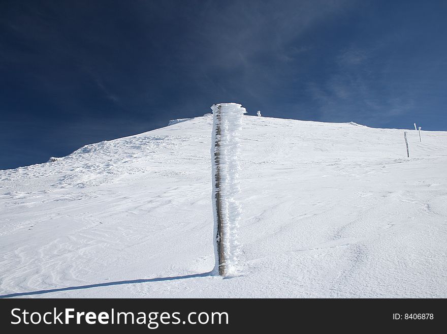 Ice stick on the mountain snow blue sky