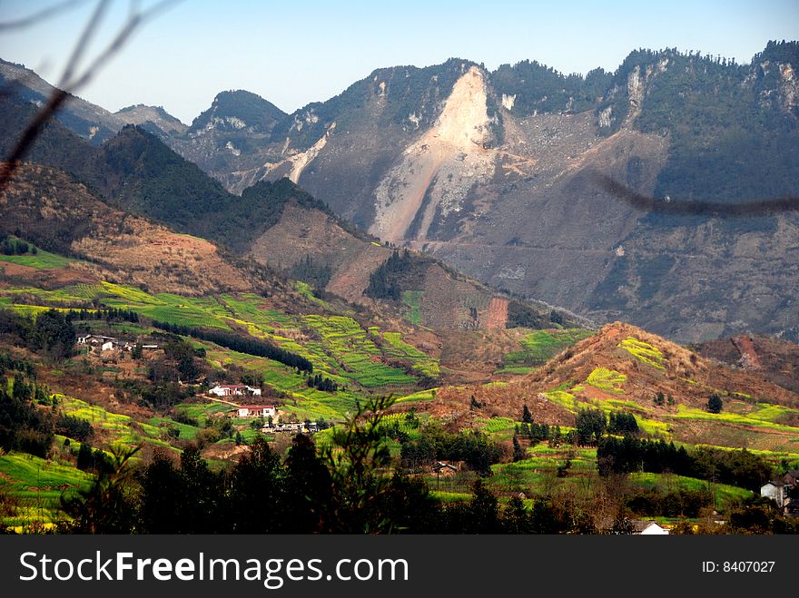 Lofty mountains tower over hilly Sichuan Province farms that rise up their slopes near Pengzhou City - Lee Snider Photo. Lofty mountains tower over hilly Sichuan Province farms that rise up their slopes near Pengzhou City - Lee Snider Photo.