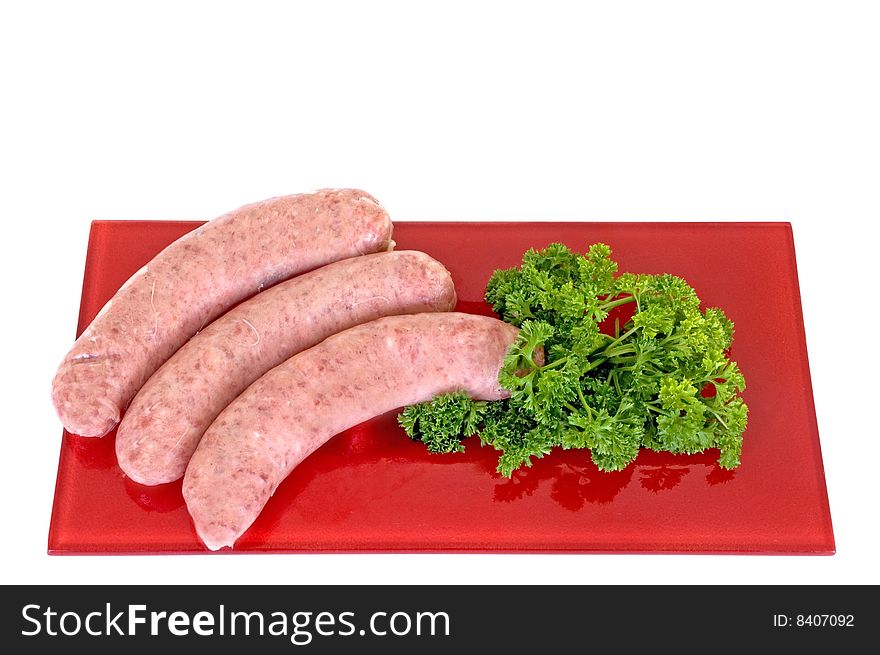 Sausages on red plate, white background, studio shot