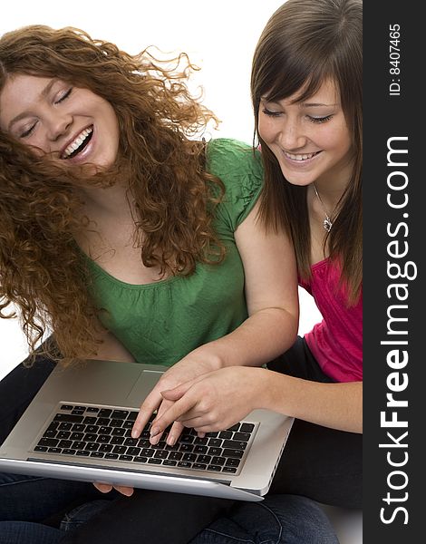Two teenagers with laptop computer, girls chat on the Internet