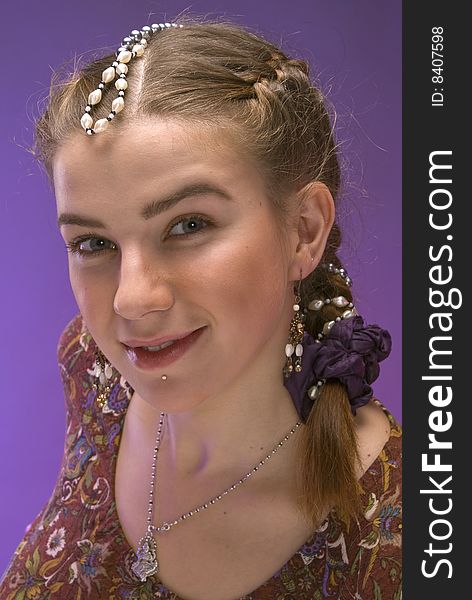 Portrait of nice young girl with plait against violet background. Portrait of nice young girl with plait against violet background