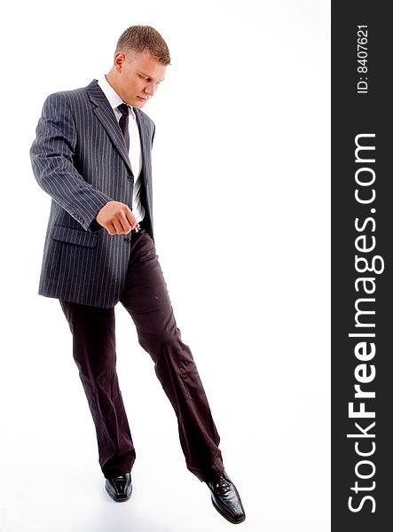 Kicking young businessman with white background
