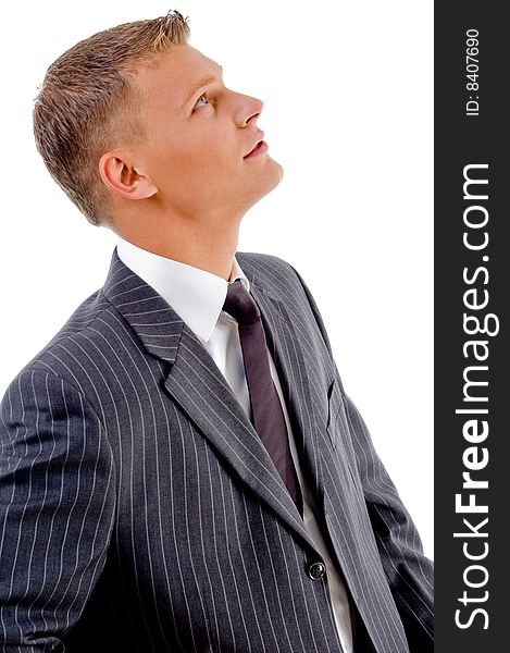Side pose of young businessman looking upward on an isolated white background