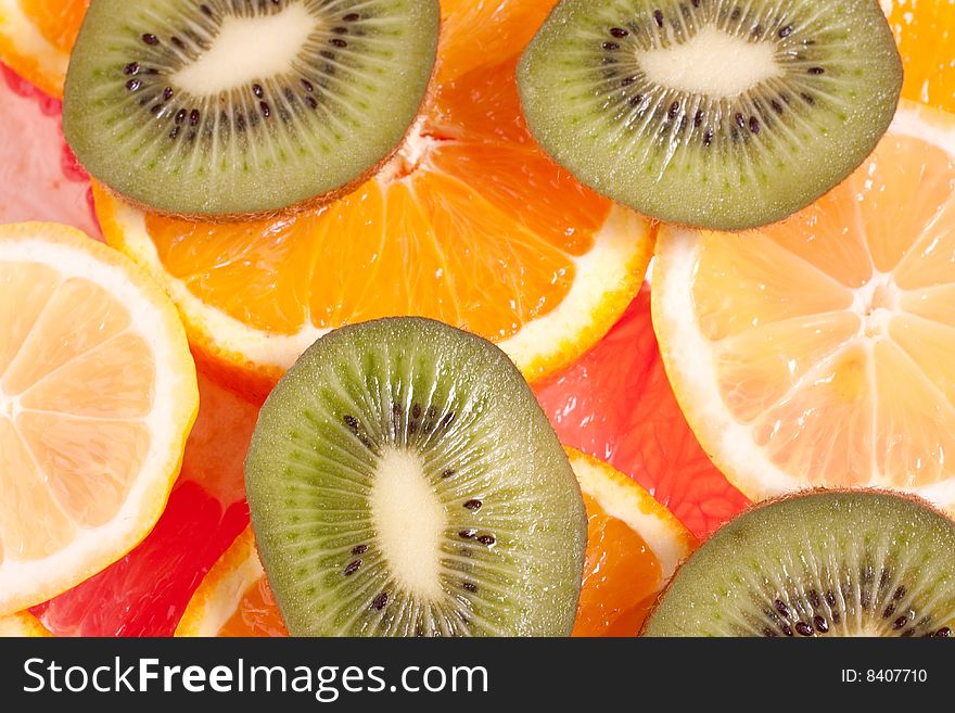 Assorted fruits of apple, grapefruit, orange, lemon and kiwi as a background