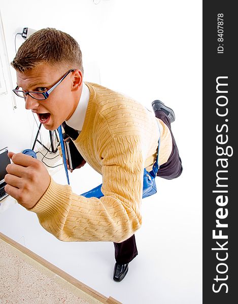 Young student carrying bag and books making his way to school on an isolated white background