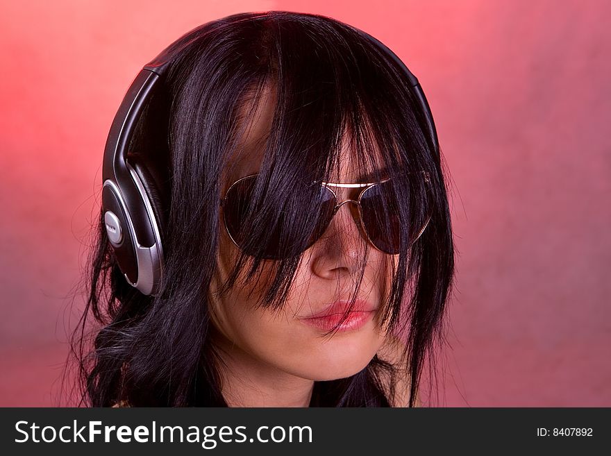 DJ girl listening music in headphones.
