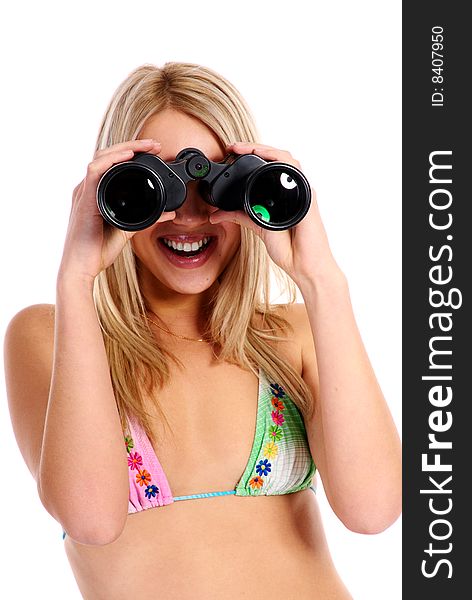 Young beautiful blond  girl in swimsuit on white background with binoculars.