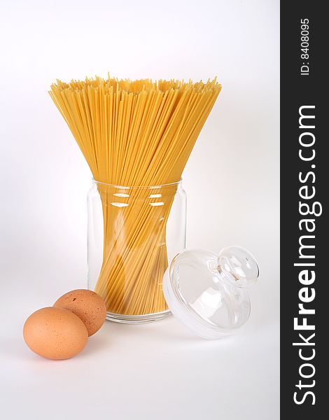Spaghetti in bowl and eggs on white background. Spaghetti in bowl and eggs on white background