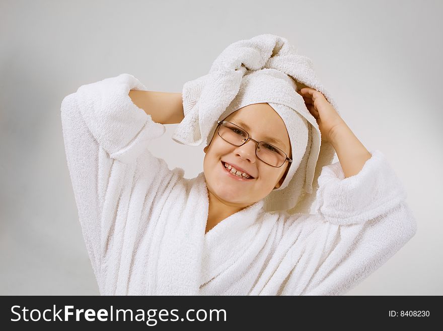 Funny looking kid with bathrobe and towel over head