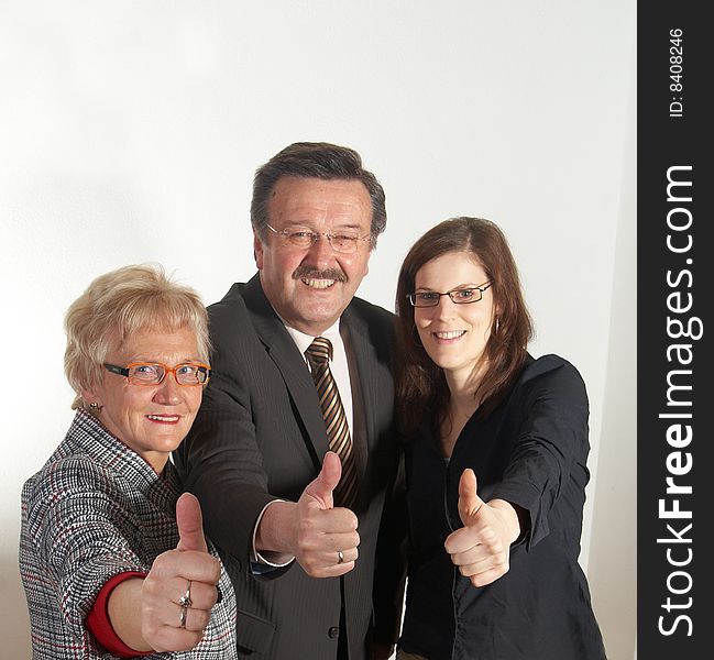 Senior business team with a young female worker giving thumbs up sign!. Senior business team with a young female worker giving thumbs up sign!