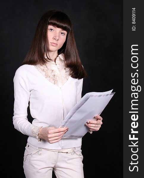 Girl with papers standing in studio