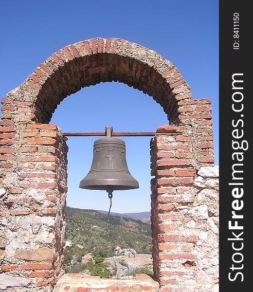 The lone bell in the ruined belfry of the Arab church on top of the mountain at Gaucin, an Andalucia white village. The lone bell in the ruined belfry of the Arab church on top of the mountain at Gaucin, an Andalucia white village