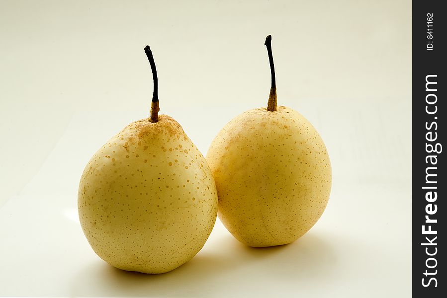 Two pears on yellow background