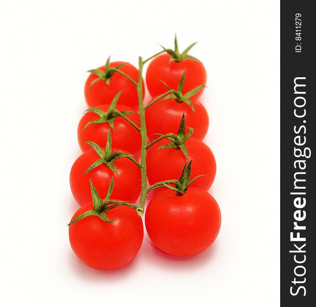 Eight cherry tomatoes on branch